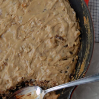 Vegan Chocolate Chip Skillet Cookie Topped with Peanut Butter Walnut Frosting