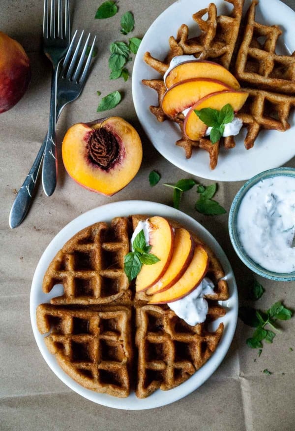 Vegan + Gluten Free Peach Waffles with Mint Coconut Whipped Cream- Perfectly crispy vegan and gluten free peach waffles, topped with vegan mint coconut whipped cream and fresh peaches!