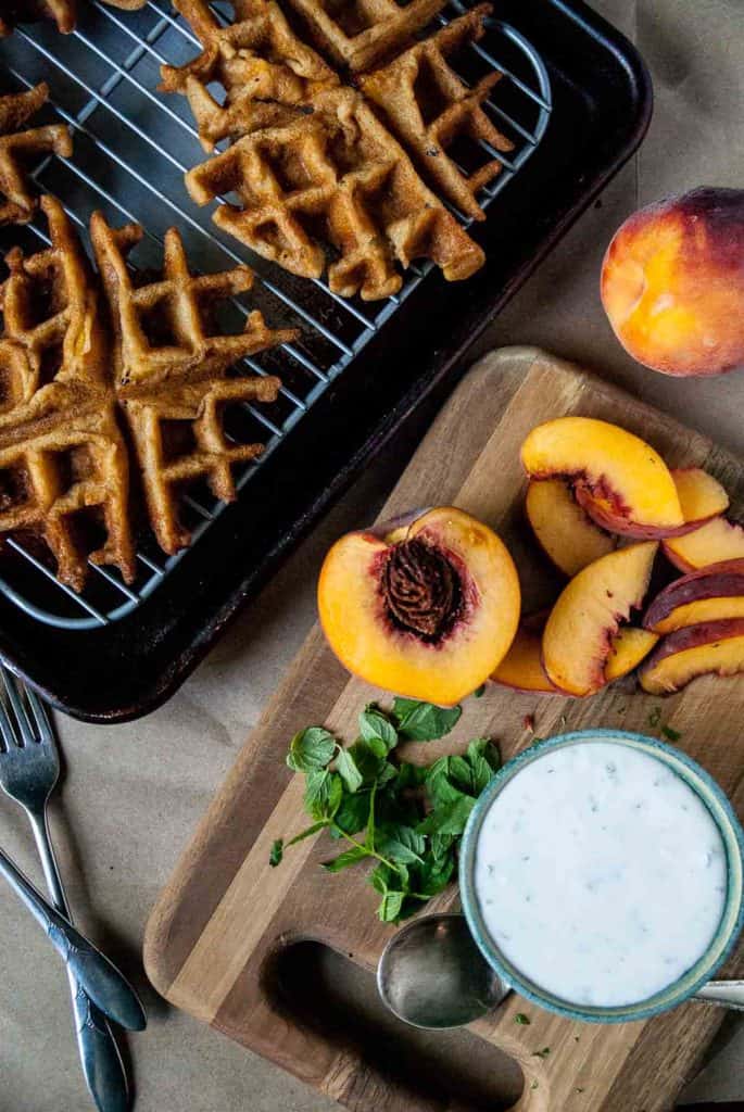 Vegan + Gluten Free Peach Waffles with Mint Coconut Whipped Cream- Perfectly crispy vegan and gluten free peach waffles, topped with vegan mint coconut whipped cream and fresh peaches!