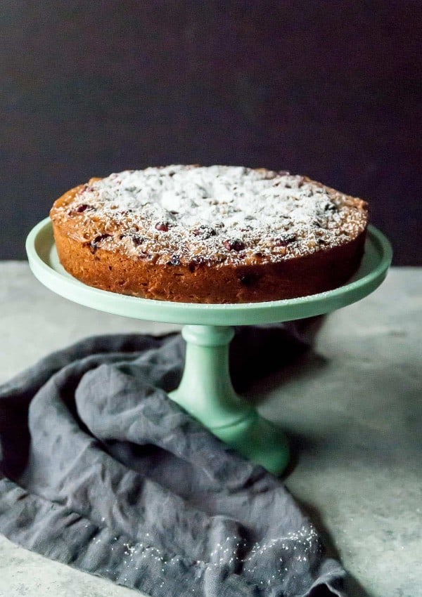 Serve up a slice of fresh cranberry ginger cake! Perfect for your holiday brunch or for your next festive dinner! Made vegan with olive oil and lots of fresh ginger.
