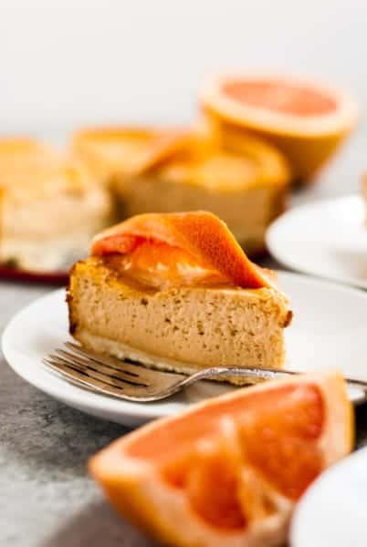 cheesecake on plate with grapefruit