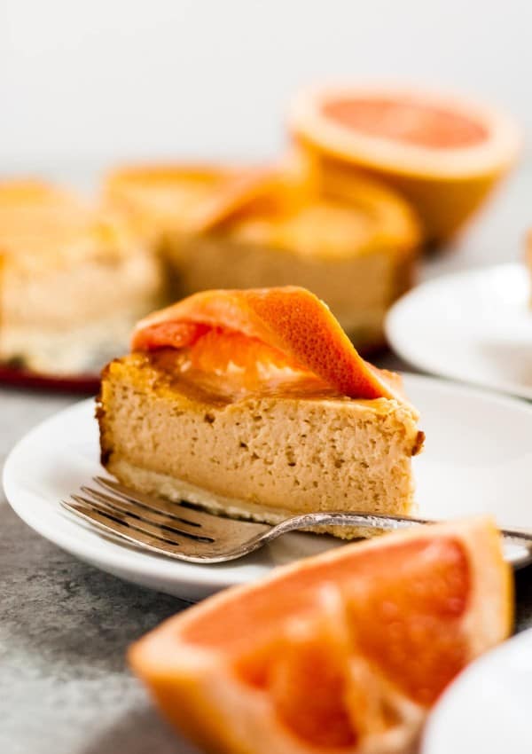 cheesecake on plate with grapefruit